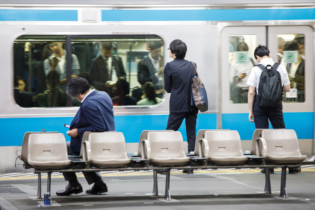 電車を待つビジネスパーソン