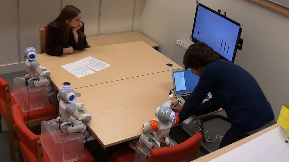 The Asch paradim in action: An adult with three robotic peers.